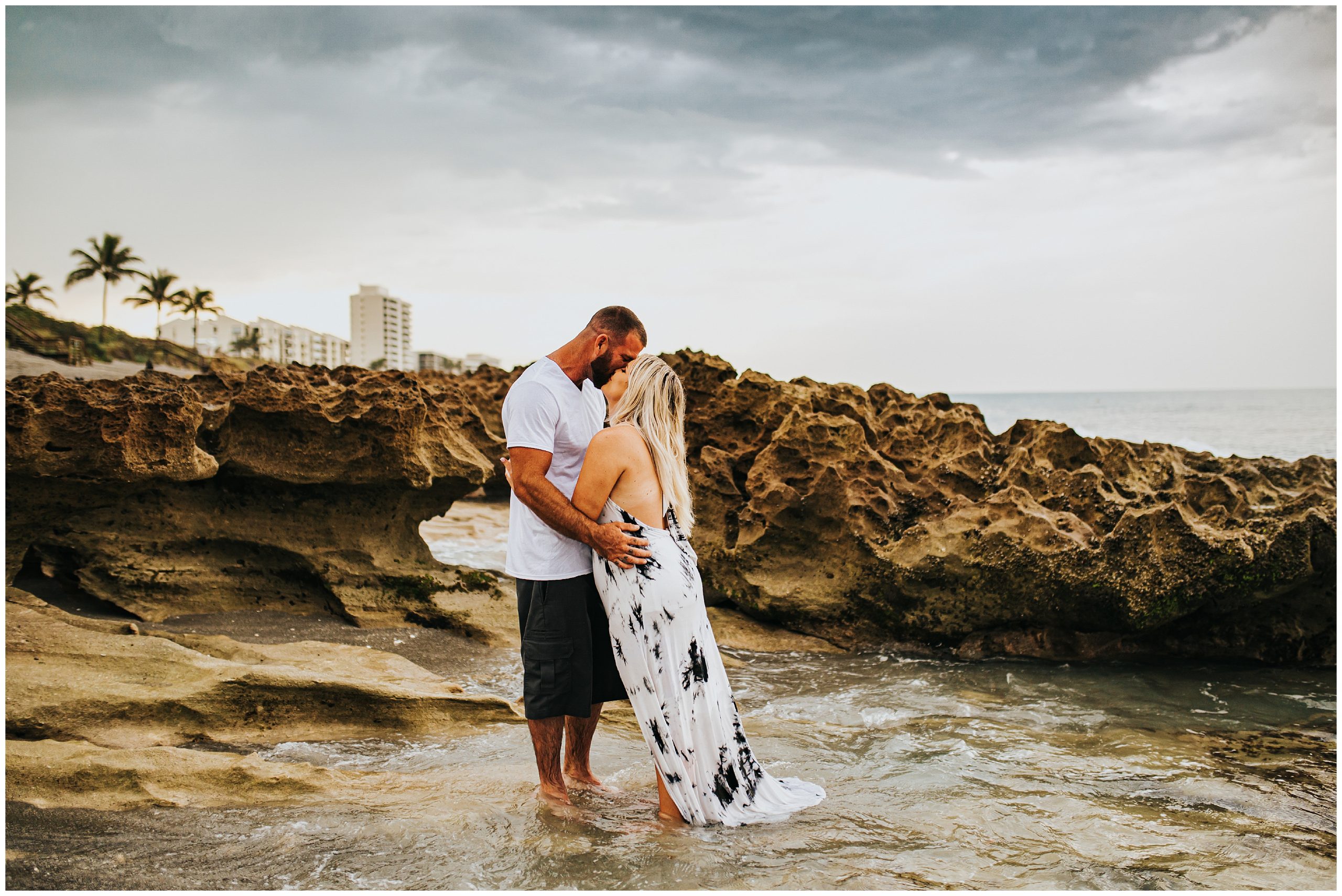 couple kissing in water during engagement photography in Florida